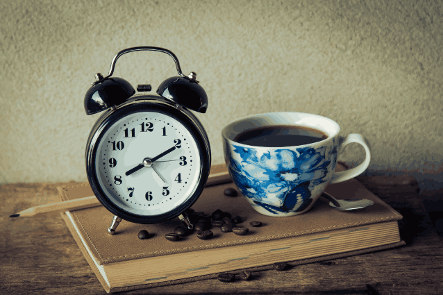 clock and a cup of coffee